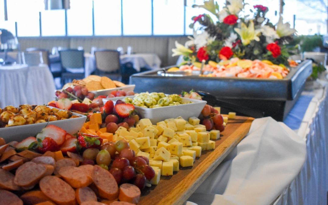 An abundant charcuterie display at Waters Edge dining at Willow Brook Run in Delaware, Ohio, showcasing the catered variety of senior community dining events.